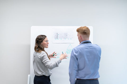 An engineer discussing data with a colleague in a meeting
