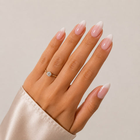 Soft French almond-shaped press-on nails, shown on a hand