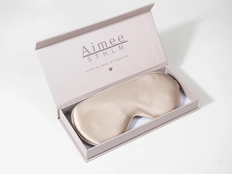 Rose-gold silk sleep mask in Aimée STHLM packaging
